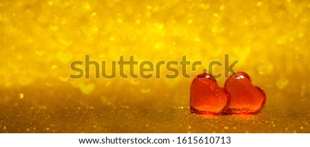 Romantic and Love banner with two red hearts on shiny gold bokeh background. Copyspace. Valentines Day concept.