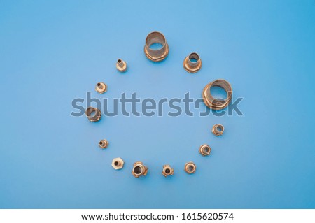 Brass adapter for connecting the hose and threaded connection. Photo on a blue background with copy space.