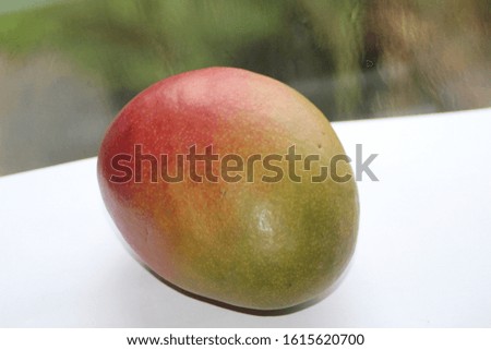 Stock image of a ripe and juicy, red and orange mango, isolated