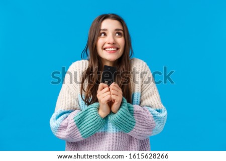 Dreamy and upbeat, thoughtful young woman dreaming how she will spend all money cashback, placed cash deposit to save-up, holding credit card, imaging something lovely, smiling