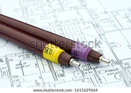 Technical drawing pens on a floor plan, blueprint.