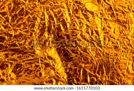 Gold crumpled foil paper texture background.