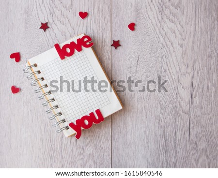 Valentine concept. Inscription Love You with hearts on wooden table background. Top view