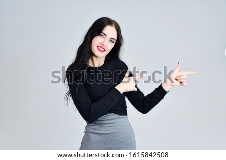 Concept of business female photo portrait with emotions. Portrait of a brunette girl with a smile with long hair with excellent makeup in a gray dress on a white background in different poses.