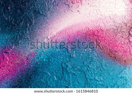 Fragment of colored graffiti painted on a wall. Bright abstract background for design.