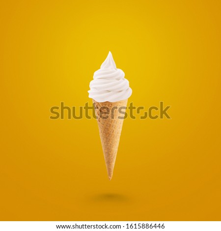 Tasty ice cream in a waffle cone on a yellow background