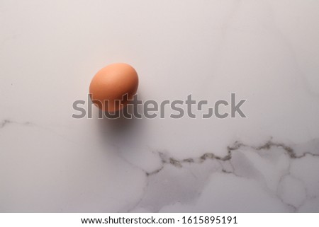 Ingredient, branding and diet concept - Egg on marble table as minimalistic food flat lay, top view food brand photography flatlay and recipe inspiration for cooking blog, menu or cookbook design