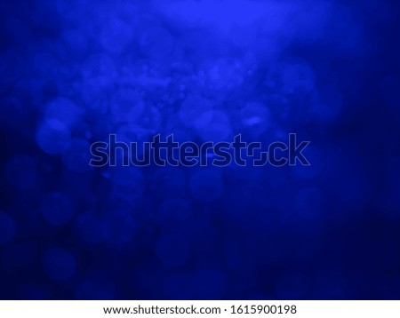 Abstract bokeh festoon on dark blue background.Blurred bright li
