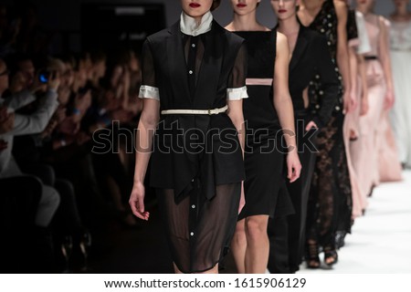 Fashion catwalk runway event, model walking the show finale. Fashion week themed photograph. Royalty-Free Stock Photo #1615906129