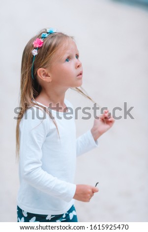 Adorable little girl playing on the beach, kids summer vacation