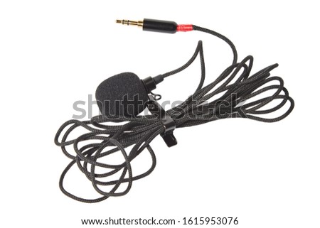 Small lavalier microphone isolated on white background. Professional sound recording equipment. Lapel mic. 