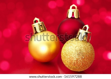 Close up of Christmas balls on red sparkle background. Christmas decorations on red background. 