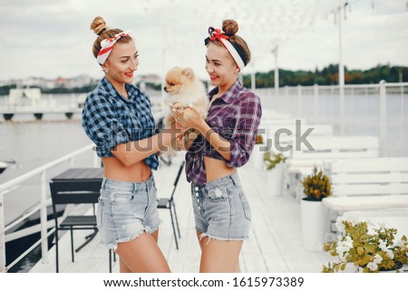 Elegant pin up ladies in a shirt in a cell. Girl with cute little dog.
