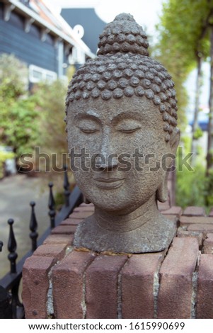 Religion sculpture in the garden. Buddha.