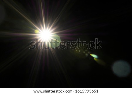 Lens Flare effect. Different colors (green, red, white, yellow) light over black background. Abstract sun burst. Easy to add overlay or screen filter over photos and images. Copy space.
