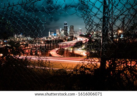 A long exposure night time of the Seattle cityscape through the famous fence location.