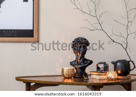 Stylish composition of elegant personal accessories at private library interior with bookstand and vintage table. Retro home decor. Candles, photo camera and a lot of books. Template. Close up.