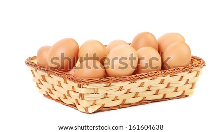 Eggs in the wicker basket. Isolated on a white background