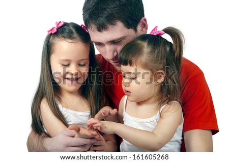 Portrait of a happy father and two beautiful little girls