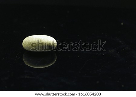 a white stone with a dark black background in a macro photo
