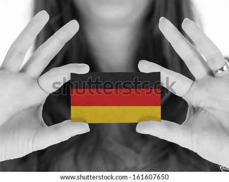 Woman showing a business card, black and white, Germany