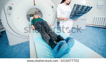 Model women doctor examine CT Scan picture