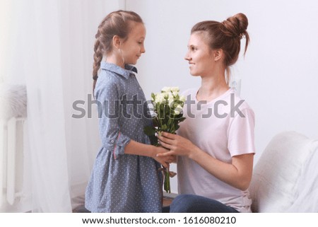 Mother's day concept. Mom and daughter at home
