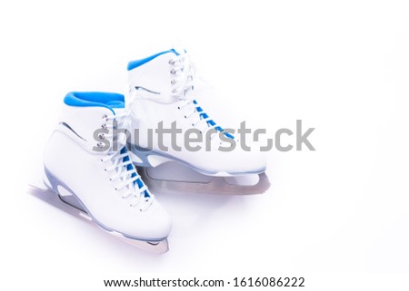 Flat lay. New white figure skates on a white background.