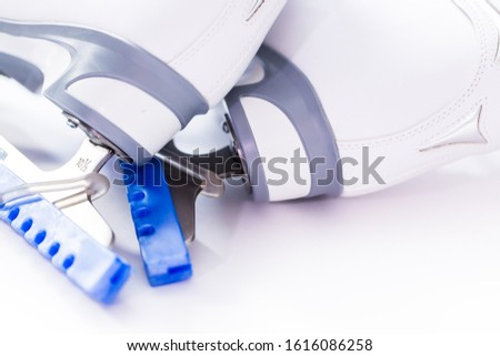 Close up view. New white figure skates on a white background.
