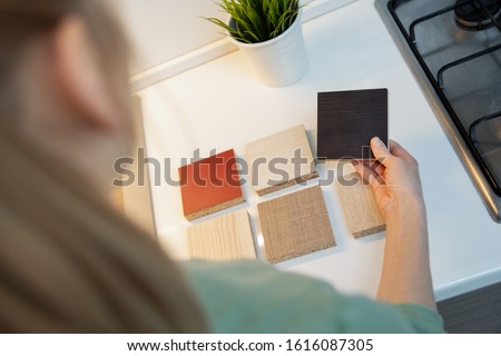 woman choosing kitchen furniture material texture