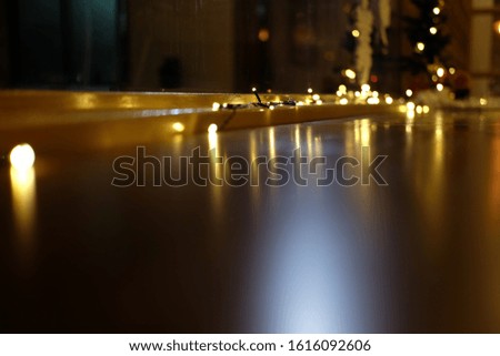 Pictures of decorative lights reflected on the night table