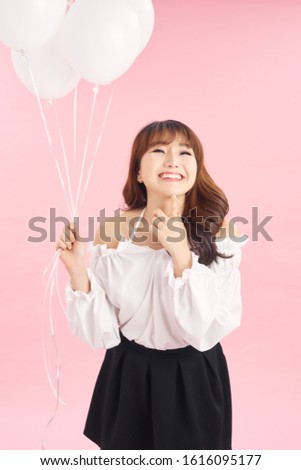 Portrait of smiling happy lady with air balloons on pink background. People concept