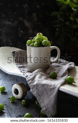 Cup oа gooseberries on the skateboard 