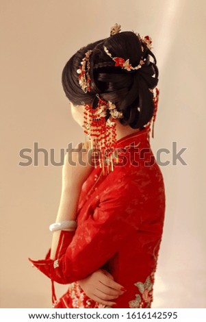 Asian petite woman wearing red cheongsam