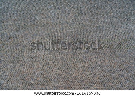 Background of stone pavement on the road in the Portuguese city of Albufeira.