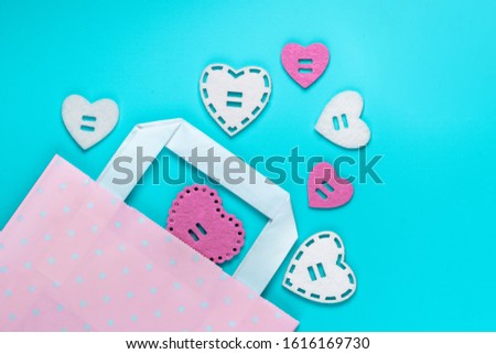 Top view holdiay background. Flat lay. Gift bag with a pile of hearts. St. Valentine's day sales, shopping concept. Don't forget to buy a present to the one you love.
