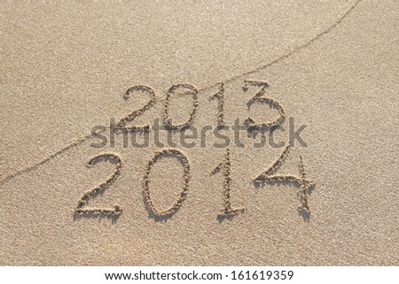 New Year 2014 season is coming concept - inscription 2013 and 2014 on a beach sand Royalty-Free Stock Photo #161619359