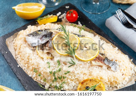 

Dorado cooked in salt with lemons and rosemary Royalty-Free Stock Photo #1616197750