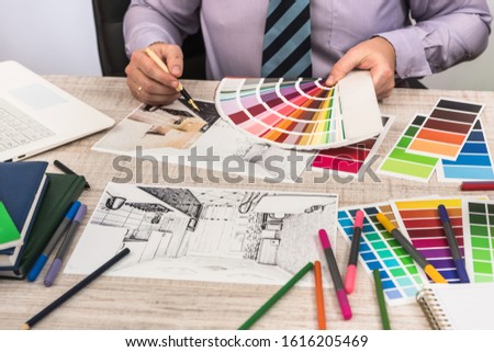 Elegant designer choosing color for painting walls your dream apartment decoration