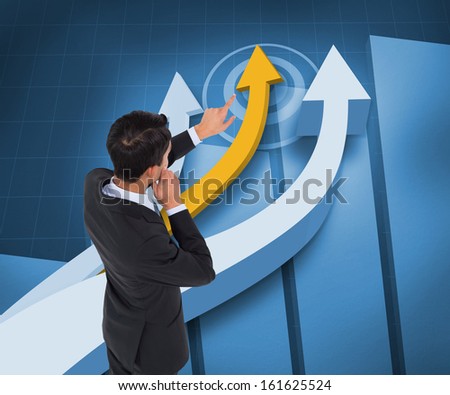 Composite image of thoughtful asian businessman pointing