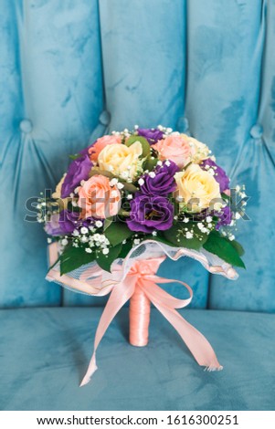 wedding bouquet stands on the couch