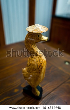 Partial and selective focus image the group of wooden duck statues. Photographed in close range, suitable for decoration and souvenirs.