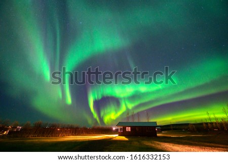 Aurora Dancing Above the hut in a small town in the countryside Iceland