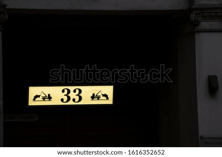 illuminated sign with the number 33 and cars