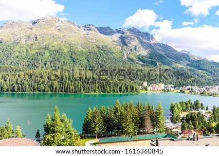 Beautiful landscape of  St Moritz lake with the Alps in the background, Switzerland including boat, resort, village and hotel