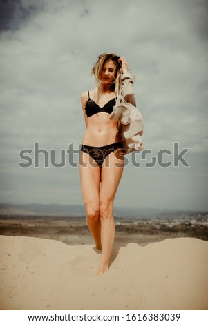 Woman with fit body portrait in desert