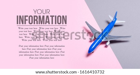 Model airplane on gray pink background, top view, space for text