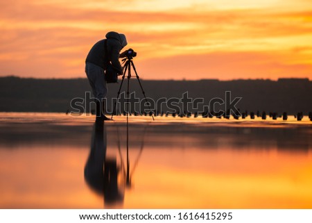 Silhouette of photographer shooting landscape