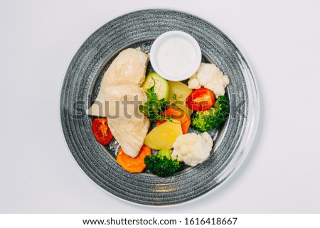 boiled chicken breast with broccoli and vegetables, healthy nutrition, on a white background