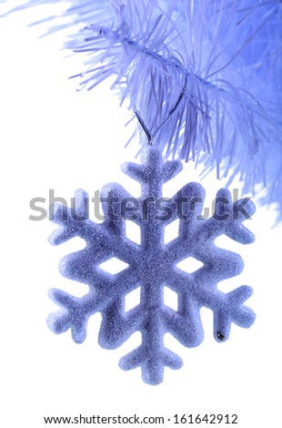 Christmas snowflake on snow-white Christmas tree close-up isolated on white